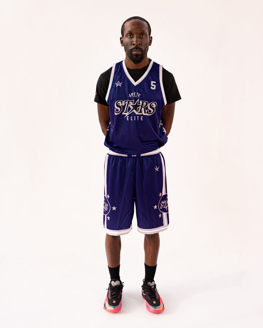 Person wearing a purple basketball uniform with 'Elite' and 'Stars' text on a white background